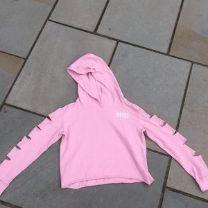 a cropped hoodie with slits in the sleeves